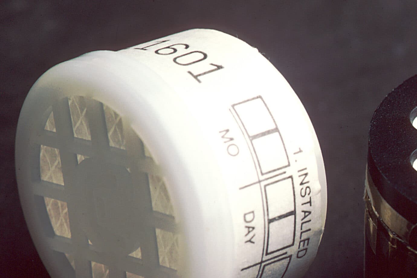 A passive radon test detector with its install-date label, ready to be placed in a home