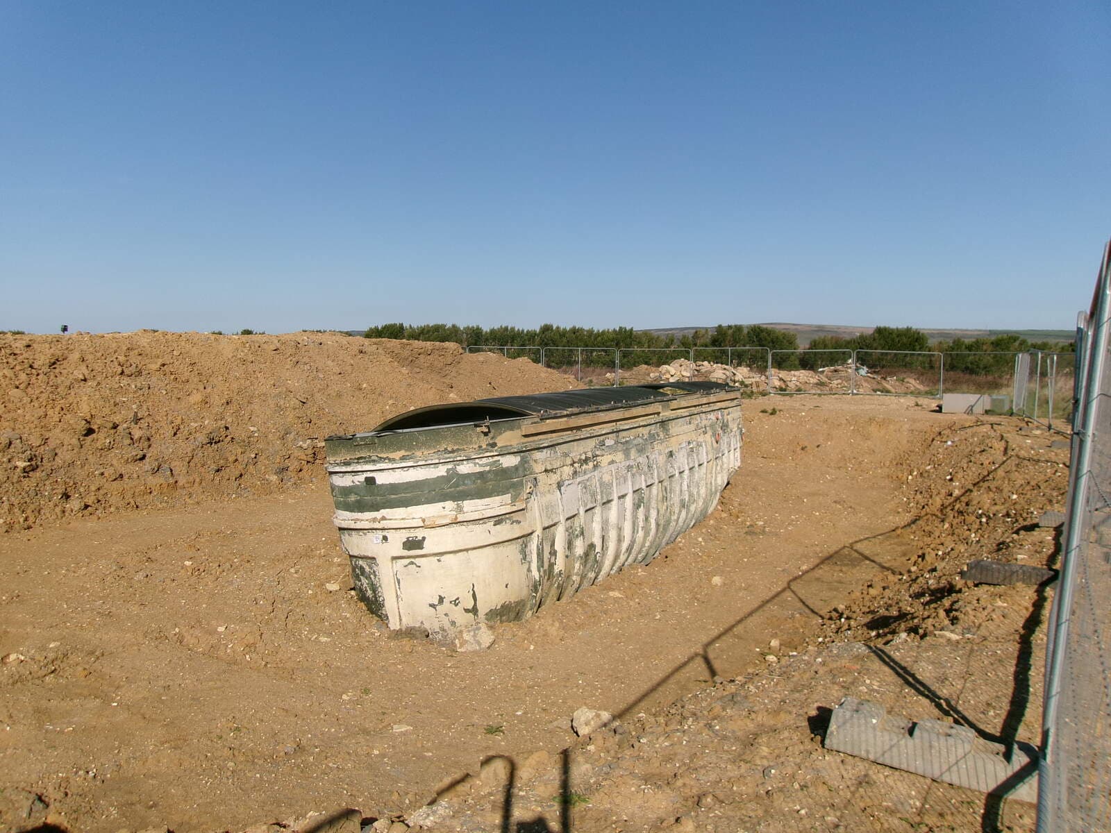 A concrete septic tank set into an open excavation