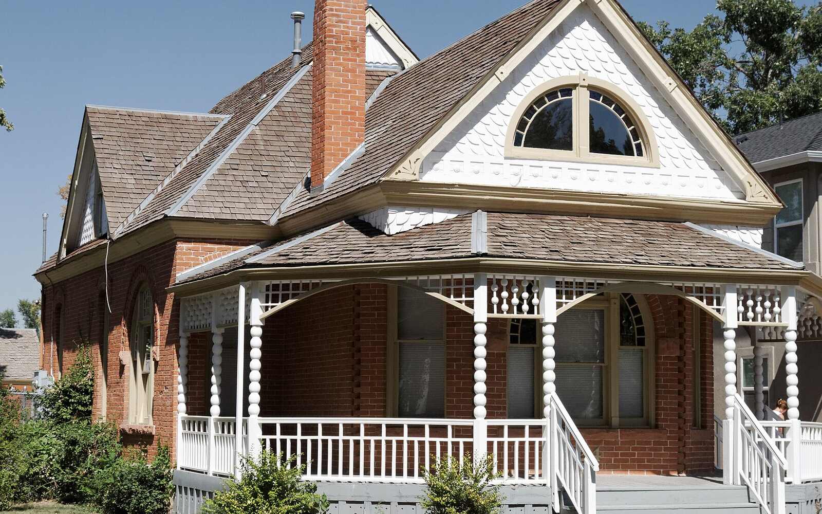 A brick Victorian home with a wraparound porch in Fort Collins, Colorado