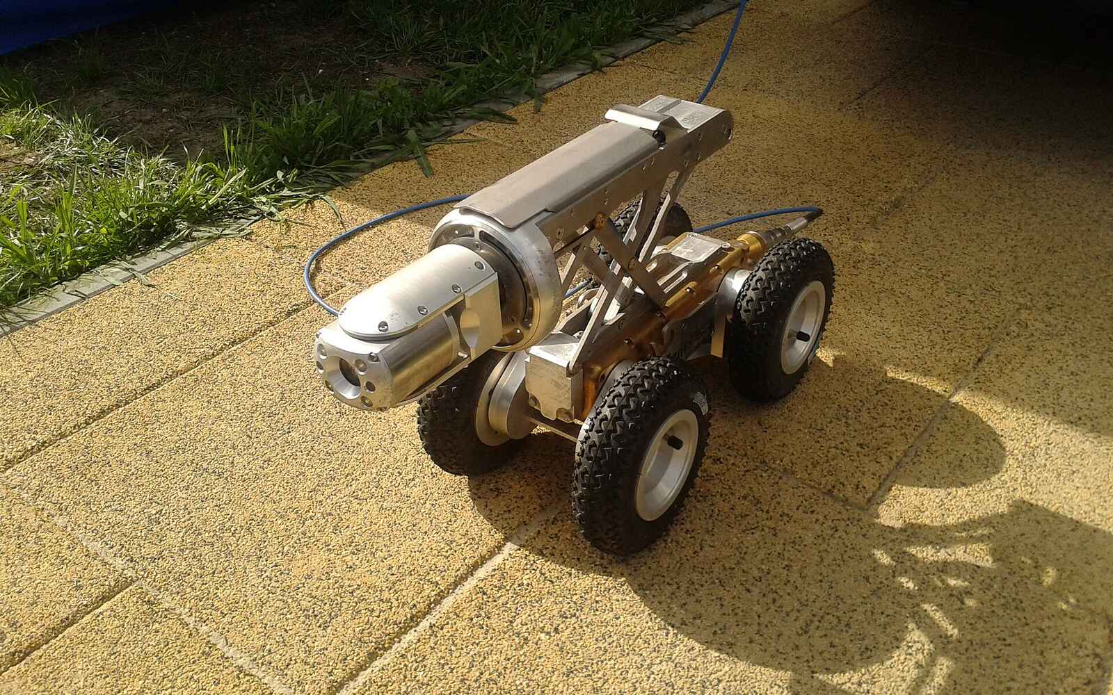 A wheeled CCTV sewer inspection crawler with its camera head and tether